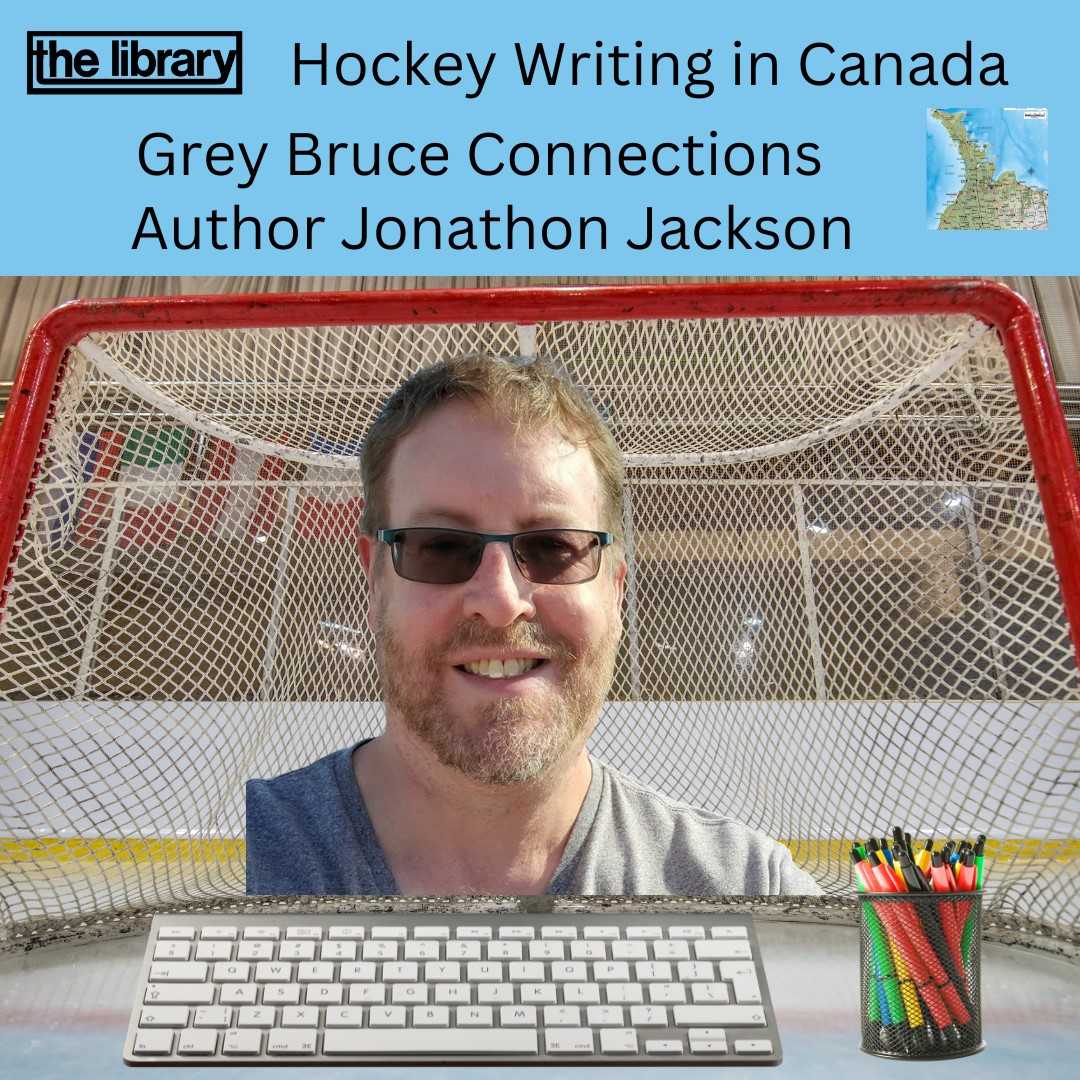 Author Jonathon Jackson in front of a hockey net with keyboard and cup of pens