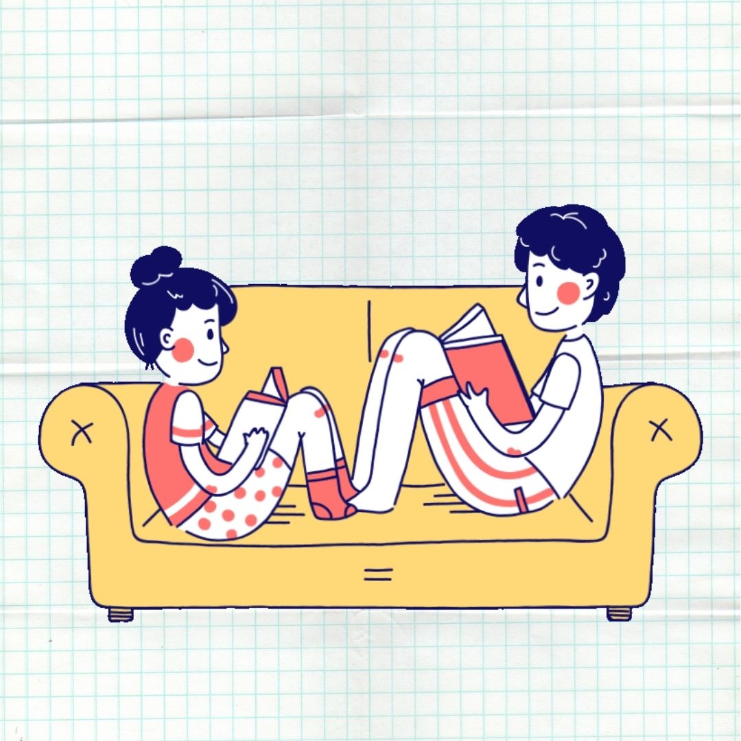 Two children on a couch reading