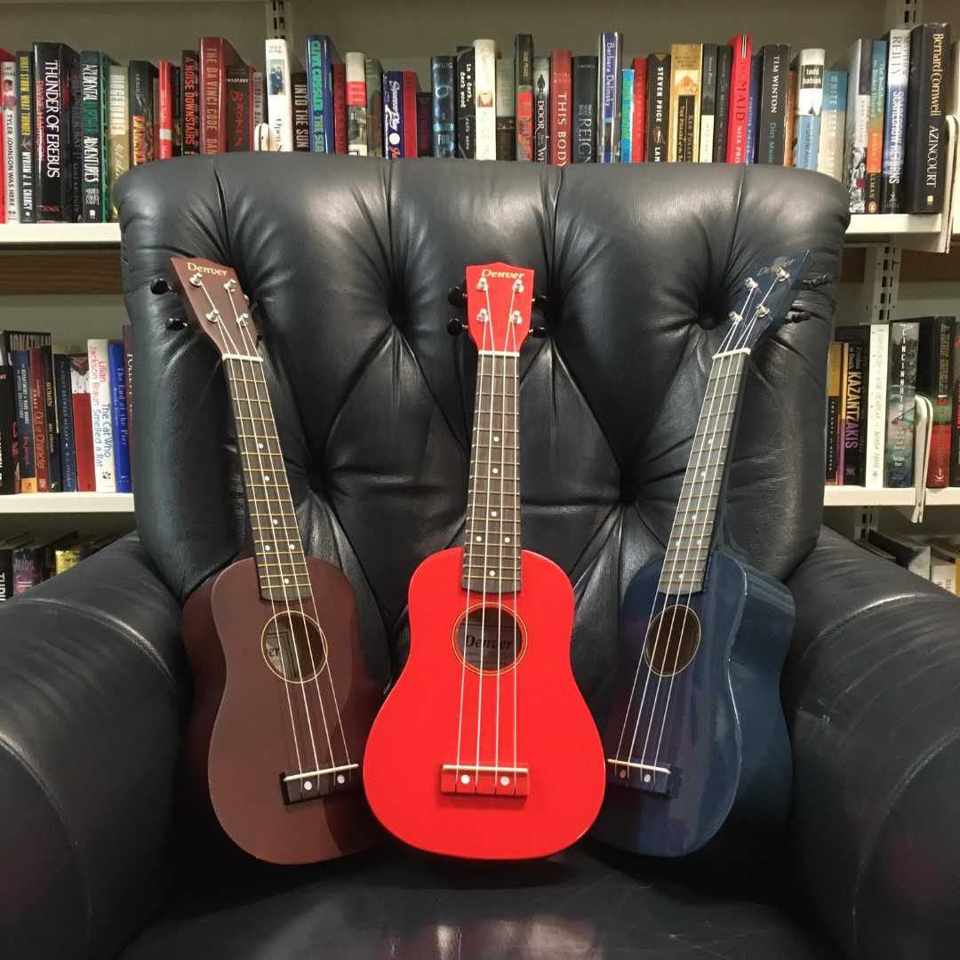 three ukuleles in a comfy chair